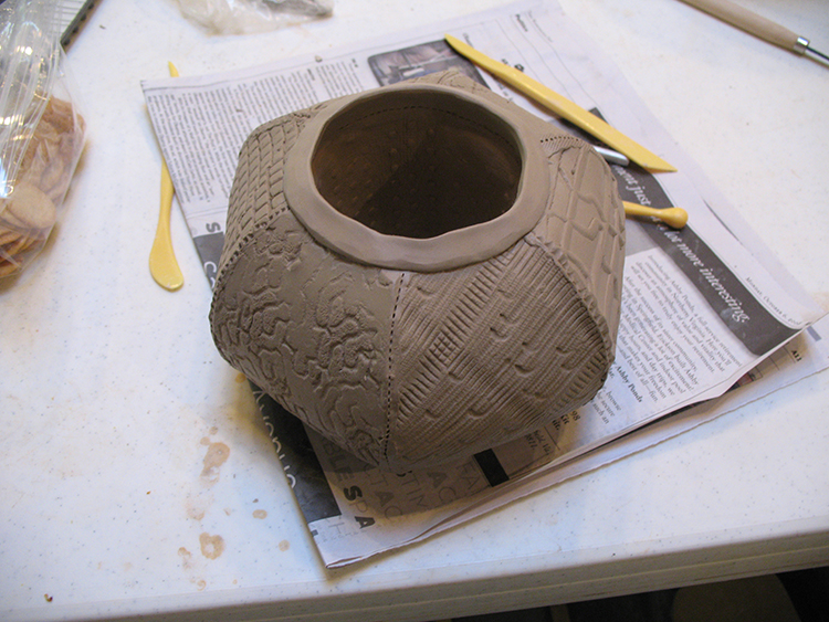 This pot is at the "workable" stage, which means you can still mould and move the clay without it breaking or cracking. Designs have been etched into each side to give a beautiful look.