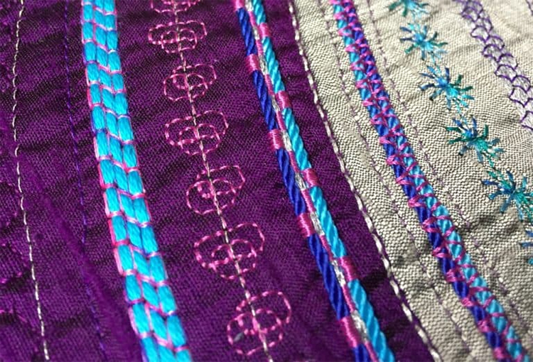This example of couching is used mostly for decoration. Although it still serves the practical use of holding the yarn in place, the colour of the thread used stands out and adds to the design.