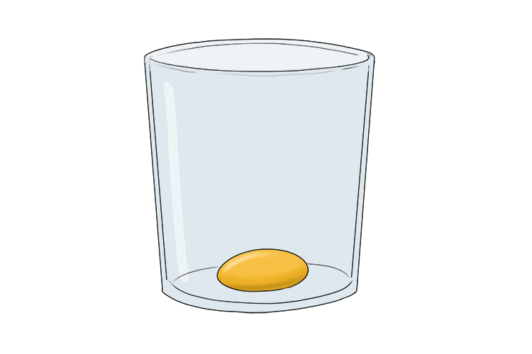 Carefully place the egg yolk into the glass.
