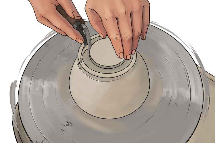 Use the rounded edge or 'beak' of the trimming tool to carve a channel into the bottom of the bowl