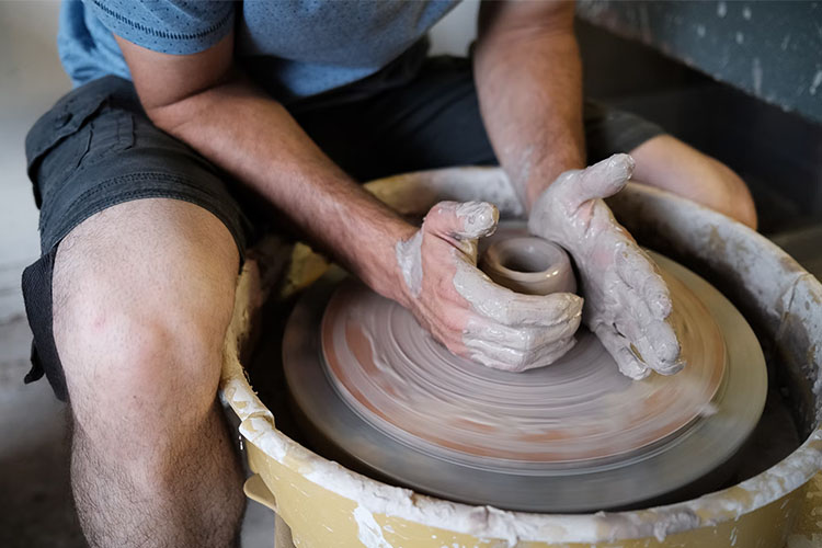 Throwing a cup on a pottery wheel