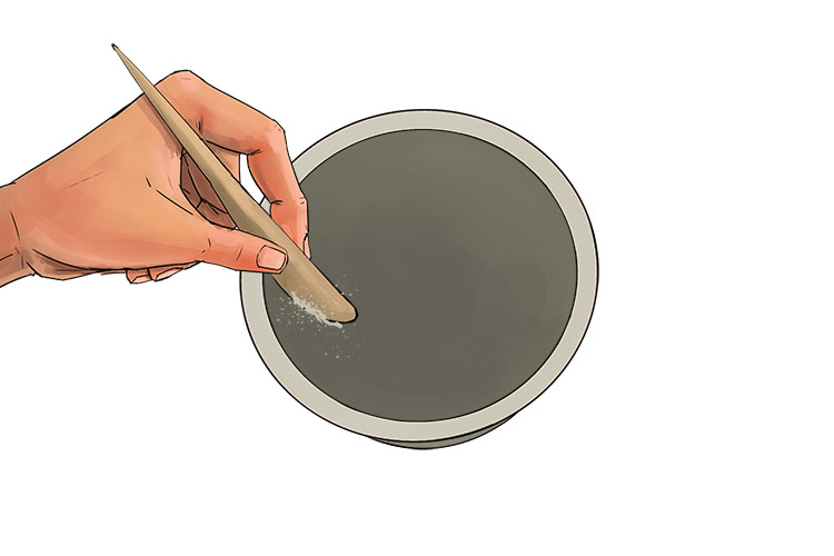 Using a curved clay carving tool, scrape the inside of each pot to remove any bumps and even out the surface as below