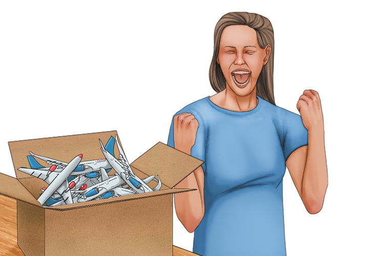 She couldn't contain her joy when she found out that the contents of the box were aeroplanes (contener).